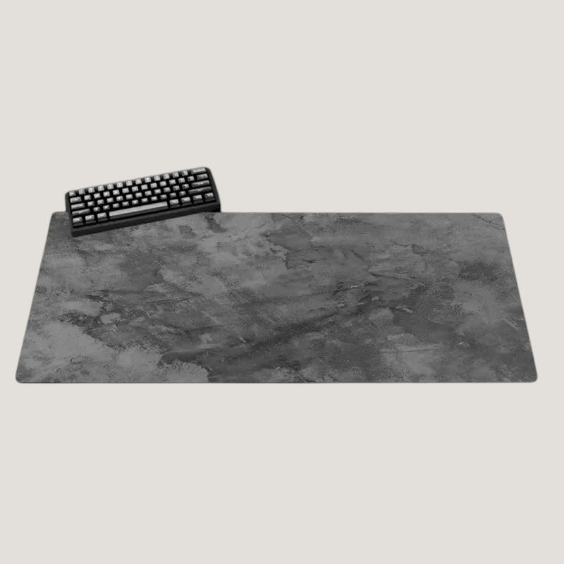 Gray Melora XL desk mat with a textured design and black keyboard on a desk