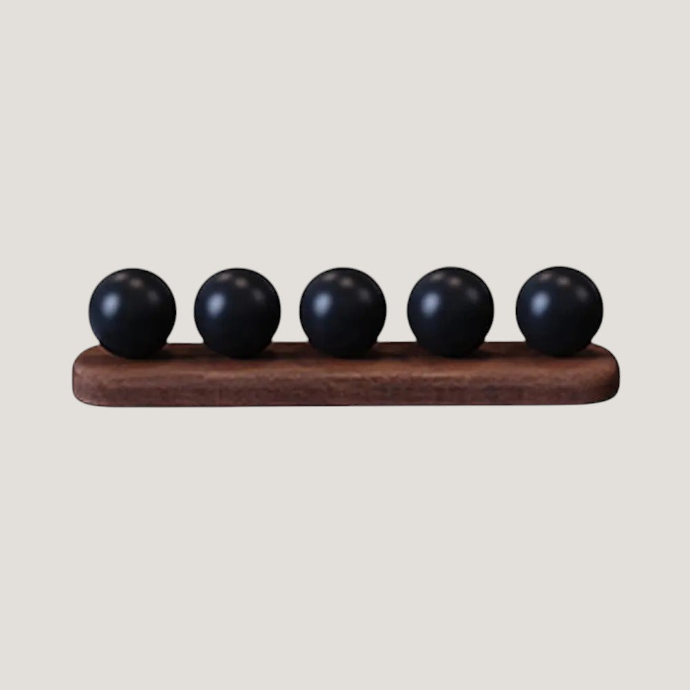 Melora cable organizer with wood base and five black cord holders on a desk