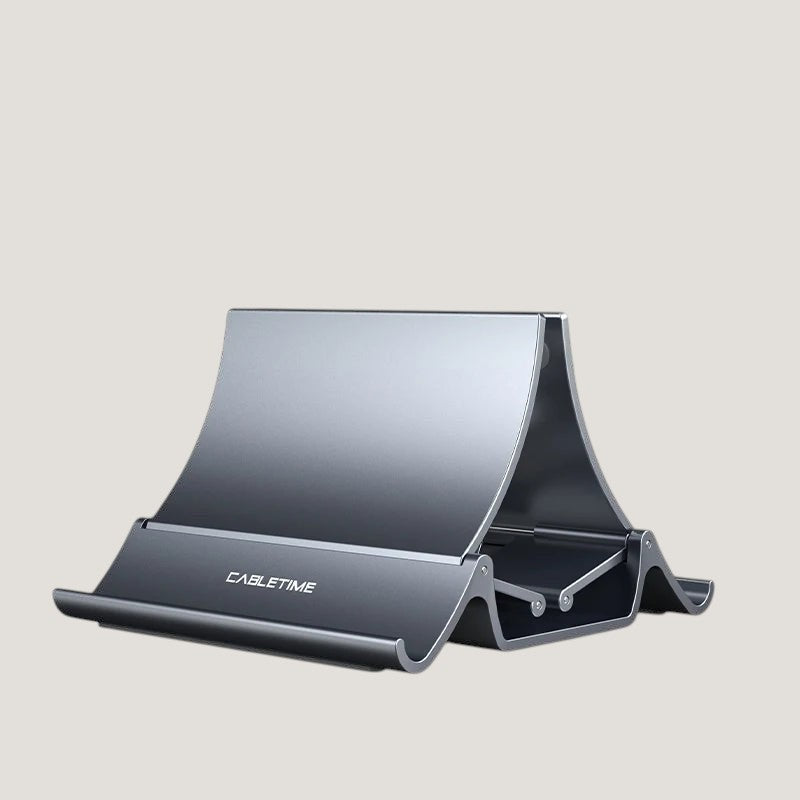 Gray Melora vertical laptop stand with silicone lining, holding a laptop, tablet and phone